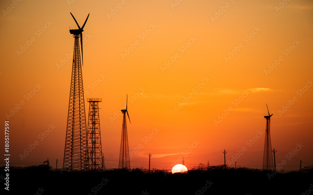 Obraz premium wind turbines at sunset