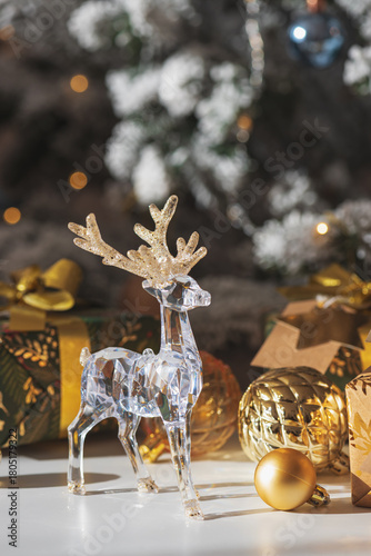 Crystal Reindeer with Gold Antlers and Christmas Gifts in Festive Interior