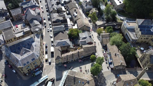 Aerial downward view of the town of Hebden Bridge looking down at the streets and buildings of the town centre showing the bridge and river