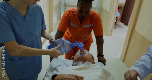 Hospital concept of 4k Resolution. Rescue workers are pushing emergency patient beds inside the hospital.