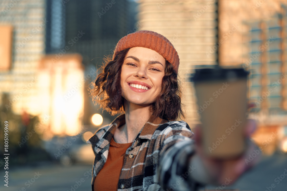 Fototapeta premium Woman smile coffee city beanie urban portrait outdoors capturing authenticity and candid lifestyle in golden hour glow, mindful living and emotional storytelling with joyful urban warmth.