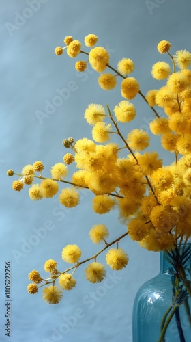 Bright Yellow Flowers in a Blue Vase Against a Soft Background