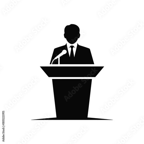 Professional speaker addressing an audience from a podium with a microphone.