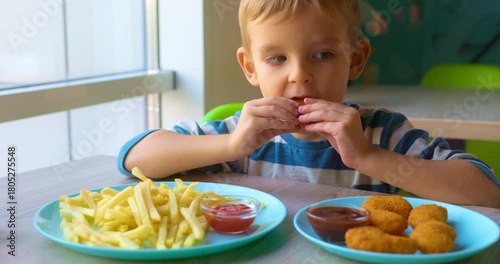 Child Enjoying Chicken Nuggets and Fries at Cafe