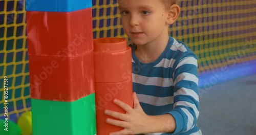 Child Building with Colorful Blocks in Play Area