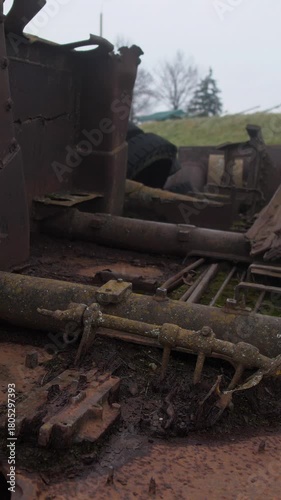 ruined vehicle relics, abandoned military transport succumbed to moss and wild flora growth, neglected battlefield machinery gradually swallowed by greenery and natural decay processes
