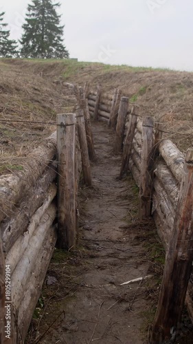 A first-person view of movement through a military trench at a fortification in Ukraine or Russia slow motion 4k