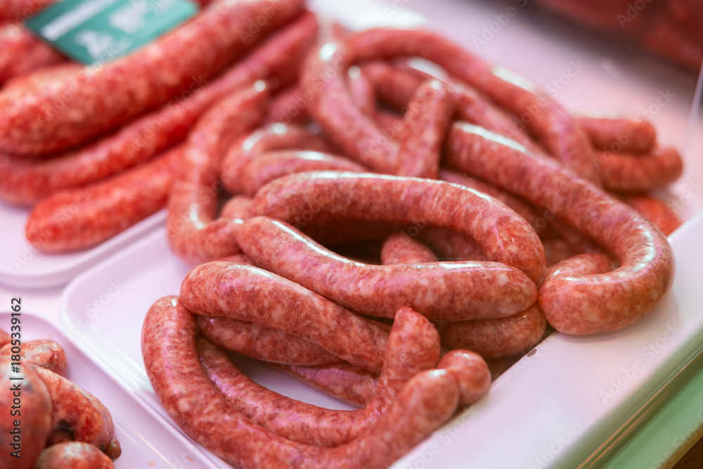 Fototapeta premium Fresh Catalan butifarra sausages made with spiced and pork. Traditional meat product of Spanish cuisine, popular in Catalonia.