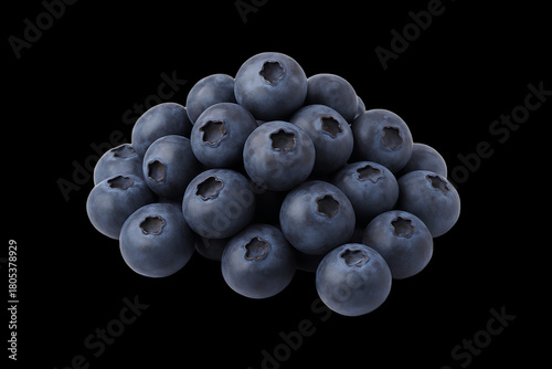 A pile of fresh blueberries stacked against a black background