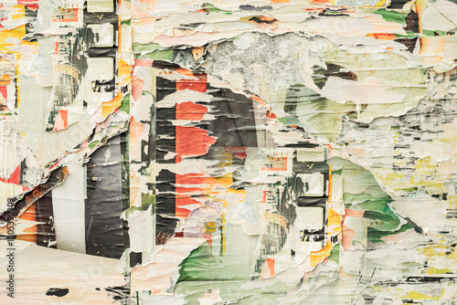 Layered street posters with torn edges revealing vibrant colors, gritty surfaces. Weathered street wall, grunge abstract background. Concept of time erosion, urban vintage, street culture expression