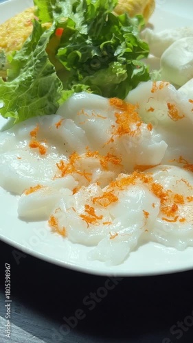 Vietnamese rice paper pancake Banh Trang Nuong served on white plate with salad bun and egg traditional street food