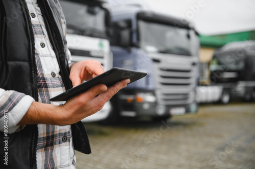 Truck fleet manager working on tablet managing logistics