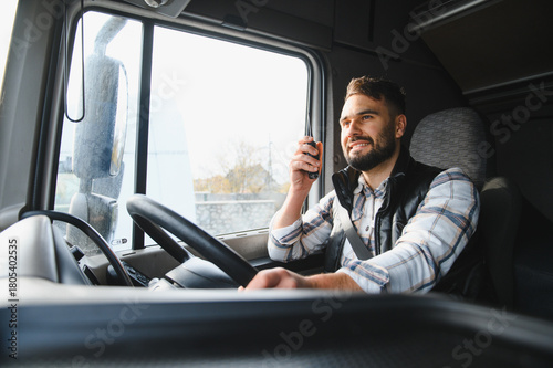 Truck driver communicating using cb radio, smiling