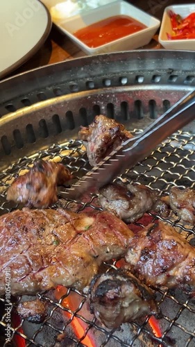 Picnic with friends. Summer barbecue with friends. Grilled pork, beef, lamb, chicken and vegetables. Close-up shot of opening the grill. BBQ meat grill for party