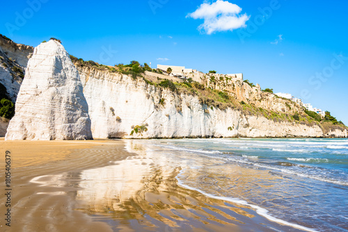 Fototapeta Naklejka Na Ścianę i Meble -  Iconic white cliffs and Pizzomunno rock rising from the sandy beach of Vieste on Italy’s Adriatic coast, Apulia, Italy