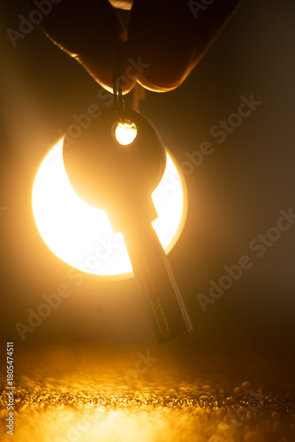 hand holding keys. man taking key to the new home. Male holding keys from new apartment. Light background. Keys concept.