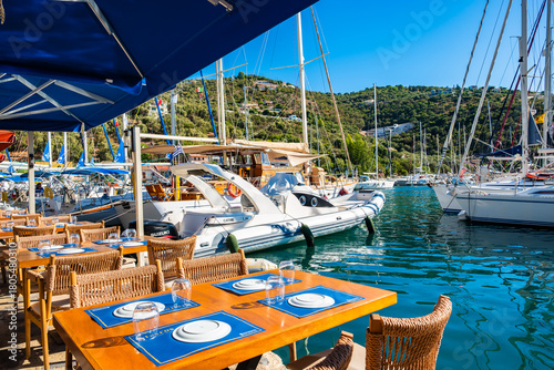 SIVOTA, LEFKADA ISLAND - SEP 21, 2025: Restaurant tables in beautiful sailing port of Sivota on Lefkada island, Greece.