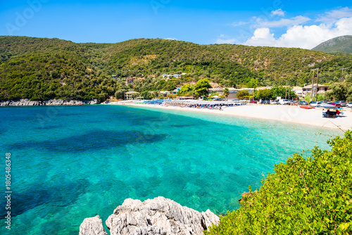 Fototapeta Naklejka Na Ścianę i Meble -  View of beautiful sandy Mikros Gialos beach with turquoise waters and lush green cliffs, Lefkada island, Greece