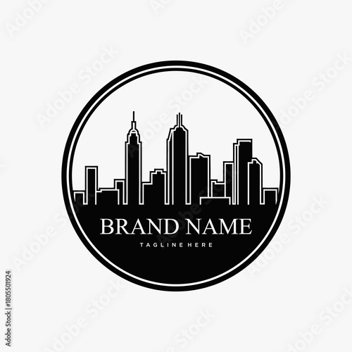 Cityscape logo design with brand name and tagline in a circular frame.