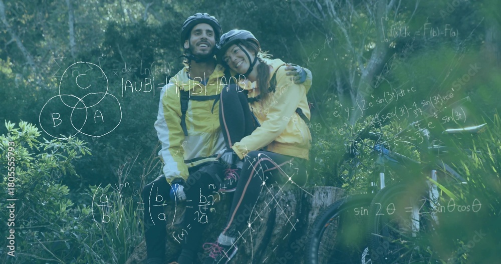 Obraz premium Sitting couple wearing yellow jackets leaning on stump in forest with mountain bikes, equations