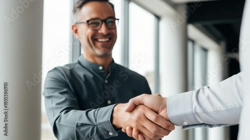Smiling Businessman Shaking Hands with Partner in Office handshake agreement