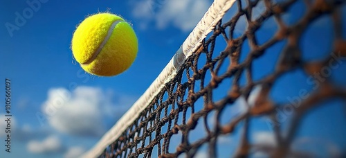 Wallpaper Mural bright yellow tennis ball flying over a net against a vivid blue sky with fluffy clouds, capturing dynamic motion and energetic excitement Torontodigital.ca