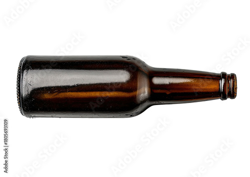 Empty, brown glass beer bottle lying horizontally