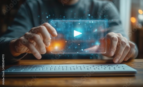 Hands interacting with a glowing holographic video player projection above a keyboard, conveying focus and anticipation
