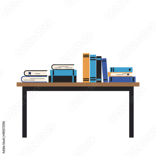 A collection of various books stacked neatly on a simple wooden table.