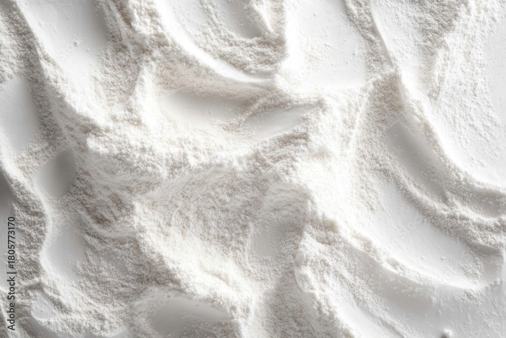 Obraz premium close-up of fine white flour spread into soft flowing ridges and valleys creating a calming tactile abstract texture