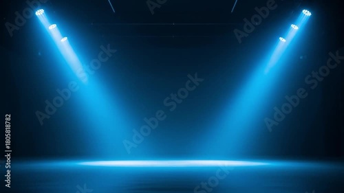 Dramatic blue spotlights illuminating an empty dark stage, concert hall, or studio background with light beams, creating an intense and focused atmosphere.