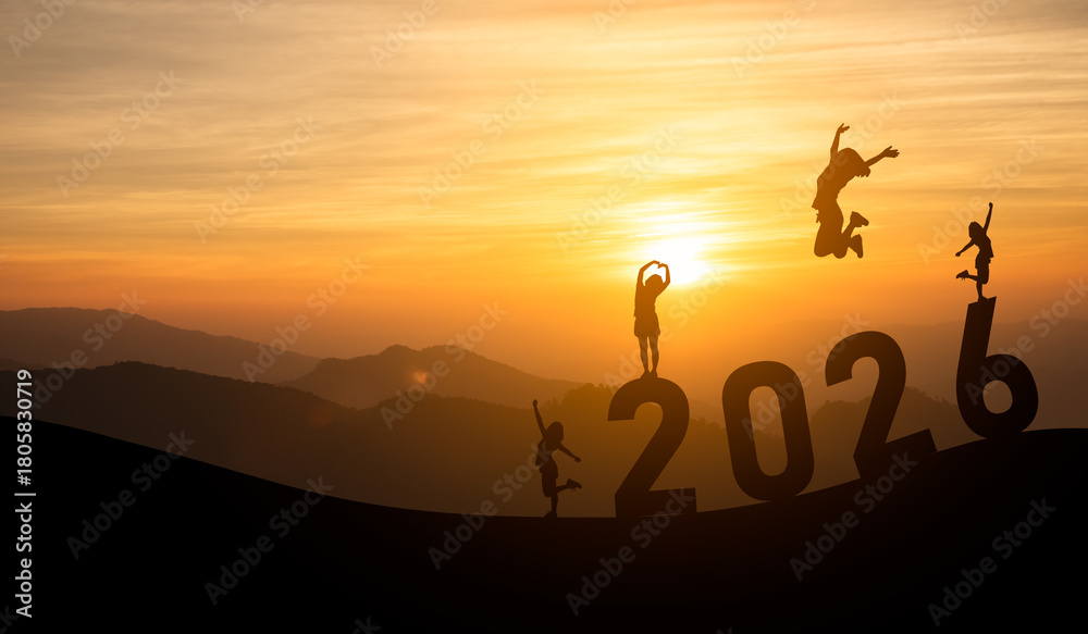 Fototapeta premium Joyful silhouettes celebrating 2026 with sunset backdrop and energetic leaps against a mountainous landscape, symbolizing hope and new beginnings