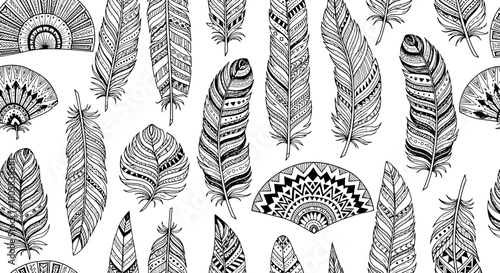 Hand-drawn seamless pattern with a collection of ornate black and white feathers in a boho, tribal style.