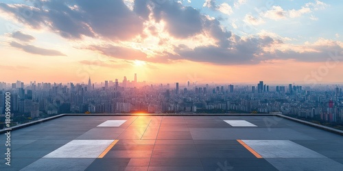 Empty rooftop helipad at sunset overlooking a sprawling city skyline with warm golden light and a calm, serene atmosphere