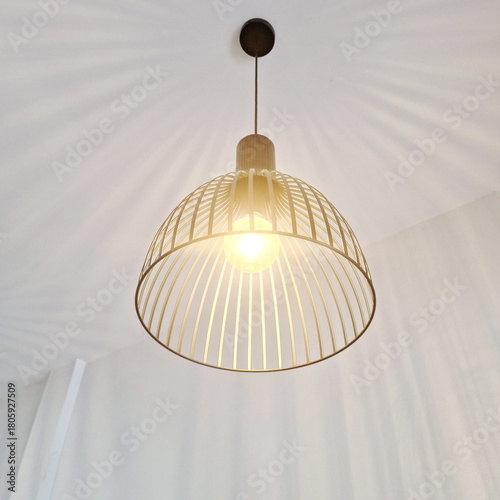 Modern Wire Pendant Lamp Emitting Warm Ambient Light in Minimal Interior Space