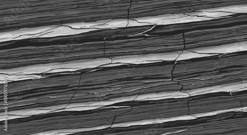 Close up of layered rock formation with distinct dark and light strata.