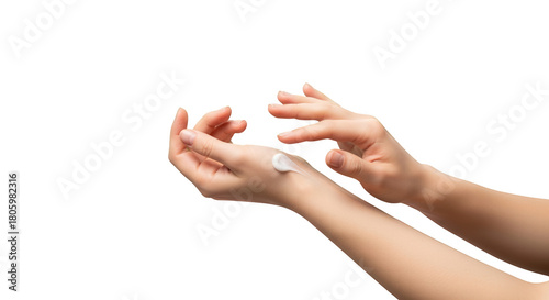 Close-up of female hands applying white moisturizing cream to delicate skin for care