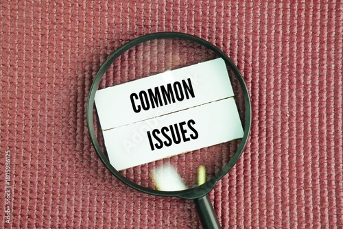 Magnifying glass and paper with the words common issues. financial problems, health issues, relationship conflicts, and work-related stress in daily life.