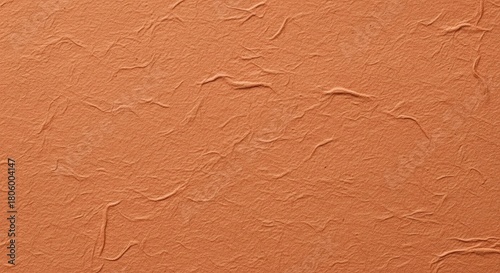 Close up of textured paper in a warm earthy orange tone offers a versatile backdrop for graphic design and creative projects