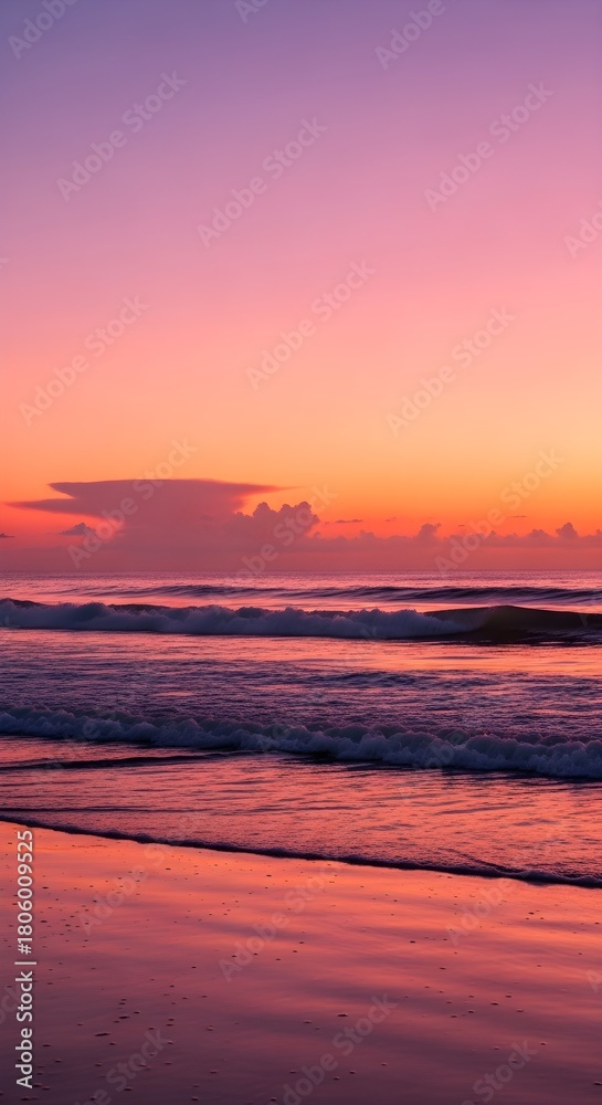 Obraz premium Sunset ocean waves crash onto a sandy beach painted in vibrant pink and orange hues