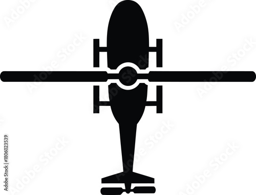 Top down silhouette of a military attack helicopter with rotor blades