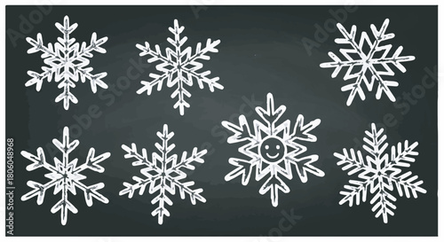 Hand drawn chalk white snowflakes on blackboard background for winter and Christmas design.