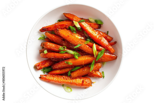 Overhead view of roasted, glazed carrots with green onion garnish in a white bowl