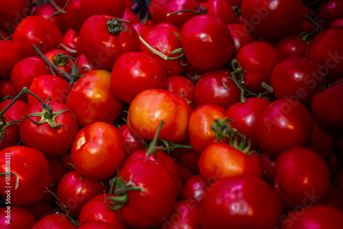 Lots of ripe, juicy tomatoes at the market. Natural nutrition and vitamins. Close-up.