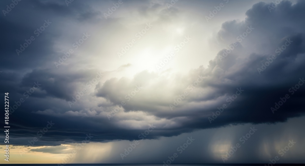 Obraz premium Dramatic stormy sky with sun breaking through dark clouds over the ocean