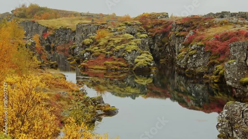A stunning view of Þingvellir (Thingvellir) National Park in Iceland during the autumn season. The footage captures the dramatic landscape of the Silfra Fissure, where the North American and Eurasian 