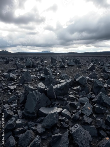 Jagged obsidian field, sharp volcanic rock glistening under moody skies, signs of past eruption,  danger,  texture