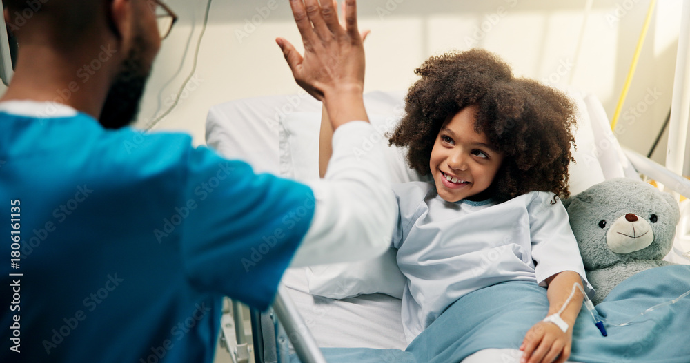 Fototapeta premium Boy, doctor and high five with smile in hospital bed, happy and care with support for recovery. Pediatrician, child and excited with teddy bear, motivation and celebration with healing at clinic