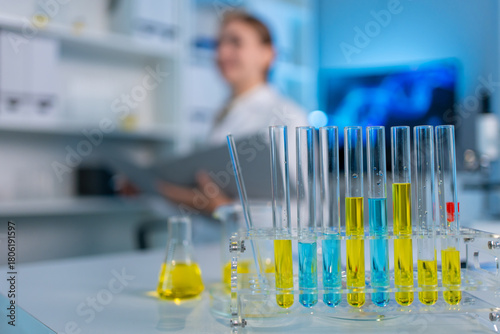 A glass tube filled with chemical liquid in biotechnology laboratory. 