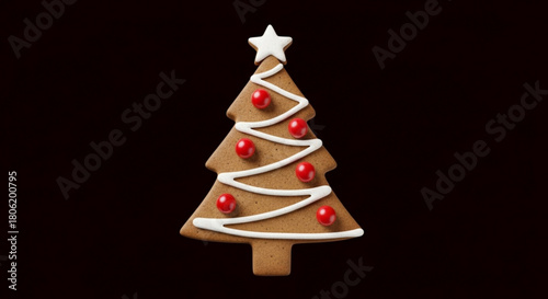A gingerbread christmas tree cookie decorated with white icing and red candy balls isolated on, festive treat for holiday season
